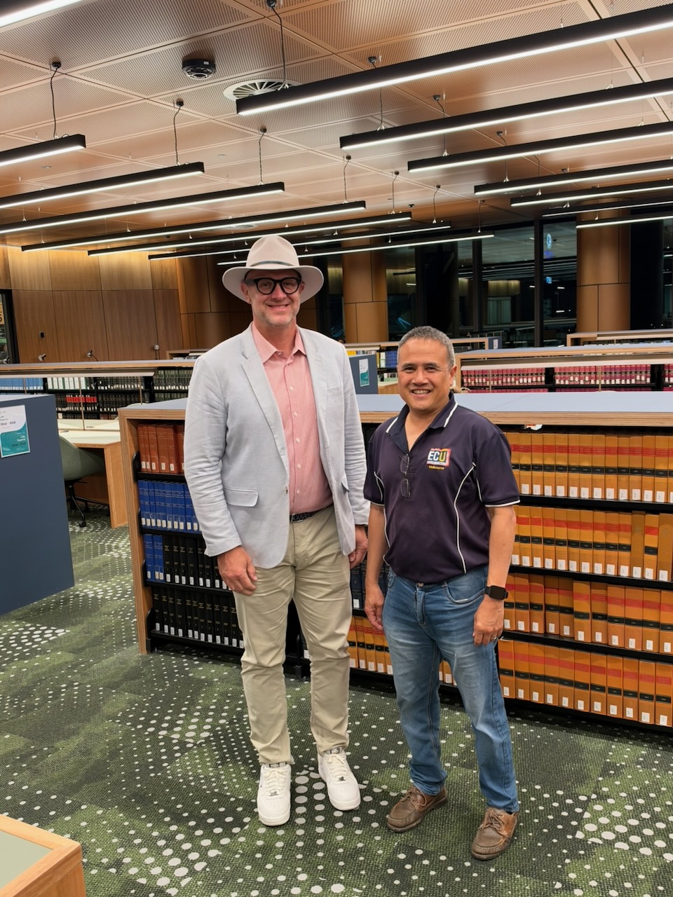 Paul Faix and Professor Pi-Shen Seet standing among the law library shelves at ECU City Campus in Perth