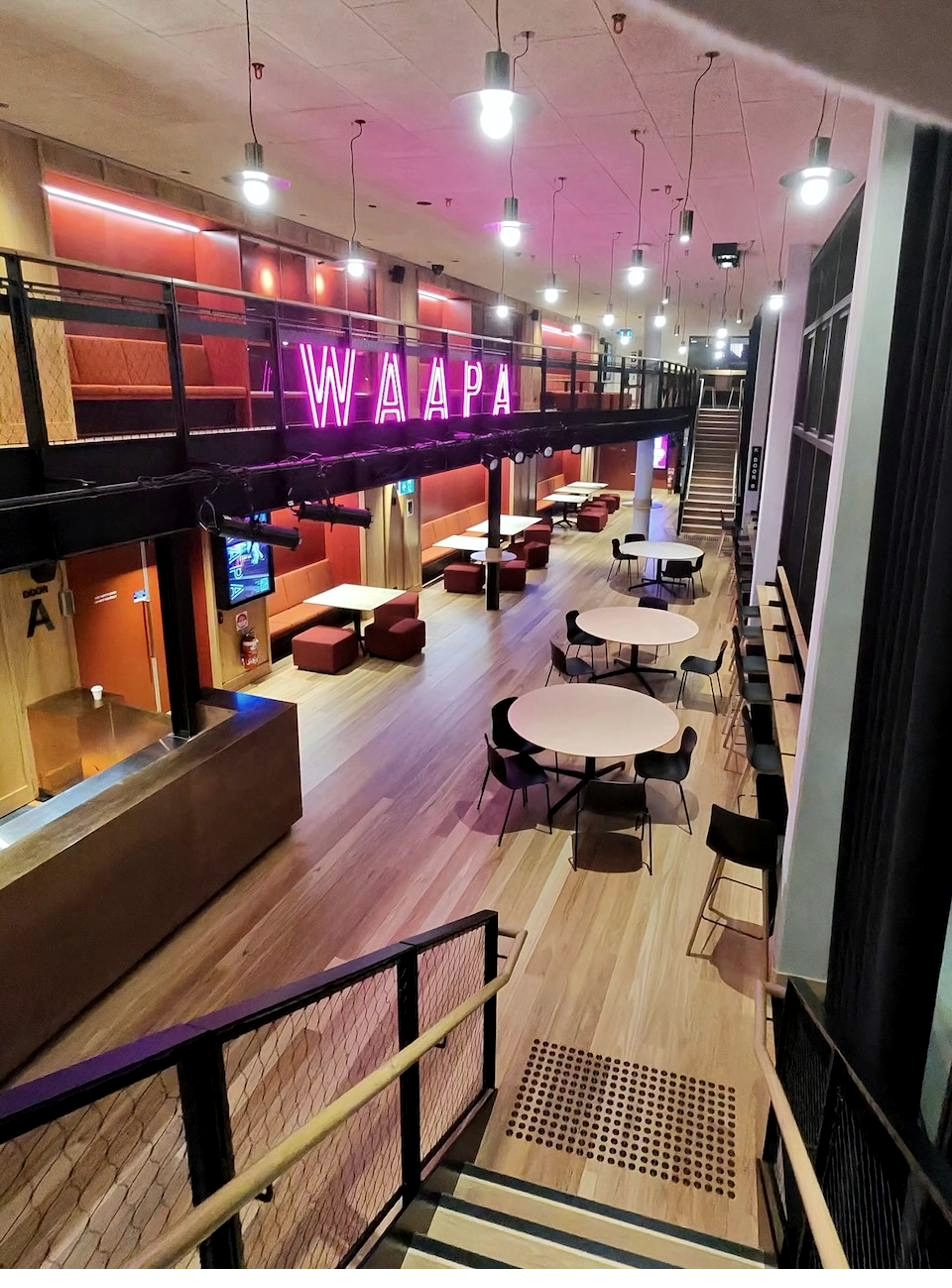 WAAPA social space with neon signage at ECU City Campus